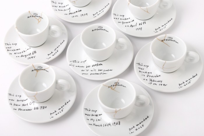 This image released by Illy North America shows a collection of espresso cups and saucers called, Yoko Ono: Mended Cups - illy Art Collection, featuring the dates and places of six tragic events written in Ono's handwriting. The collection is inspired by Kintsugi, the Japanese technique of repairing cracked pottery with brushstrokes of gold. The line for illy Art Collection is being released alongside Onos upcoming show at the Museum of Modern Art. (Lou Manna/Illy North America via AP)
