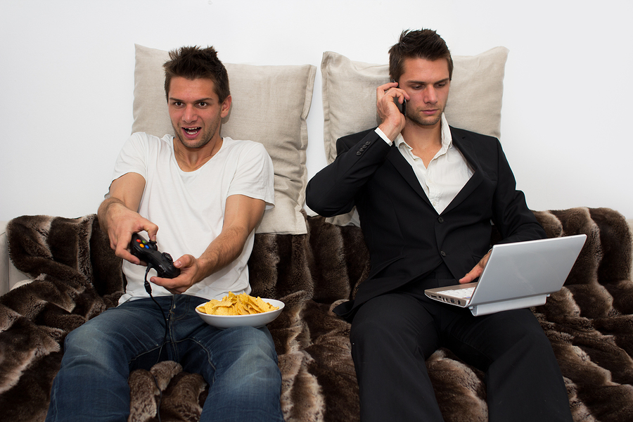 Gamer and Businessman side by side on the couch