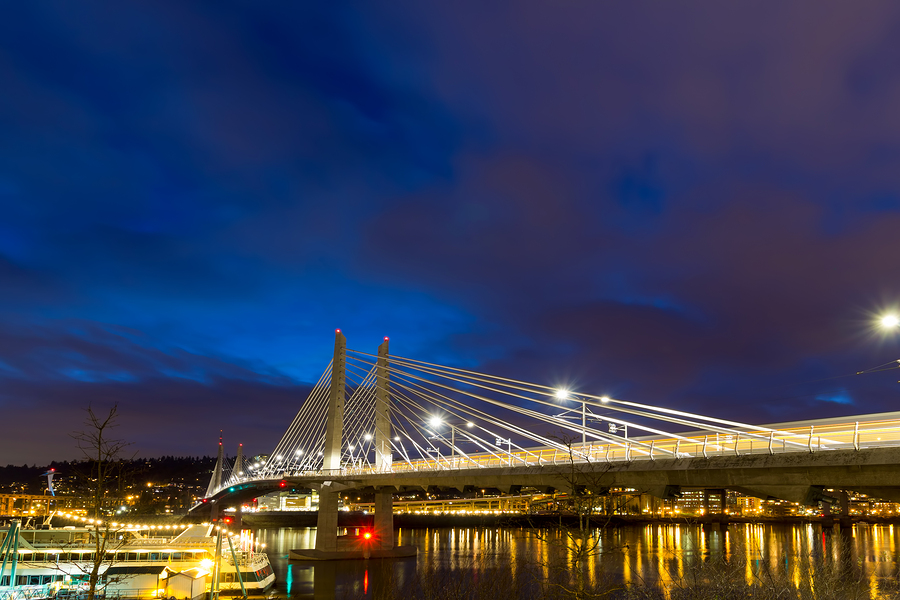 Train Light Trails on Tilikum Crossing Bridge over Willamette River in Portland Oregon during Evening Blue Hour